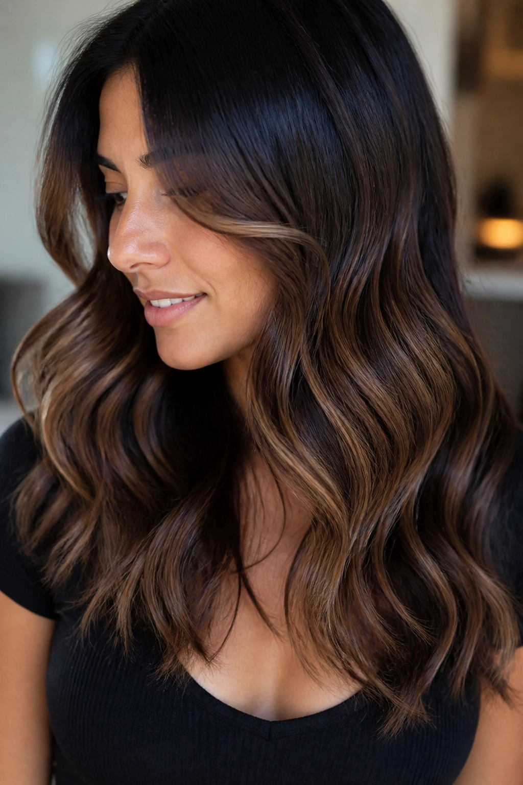 Wavy brunette with honeyed ribbons along the layers