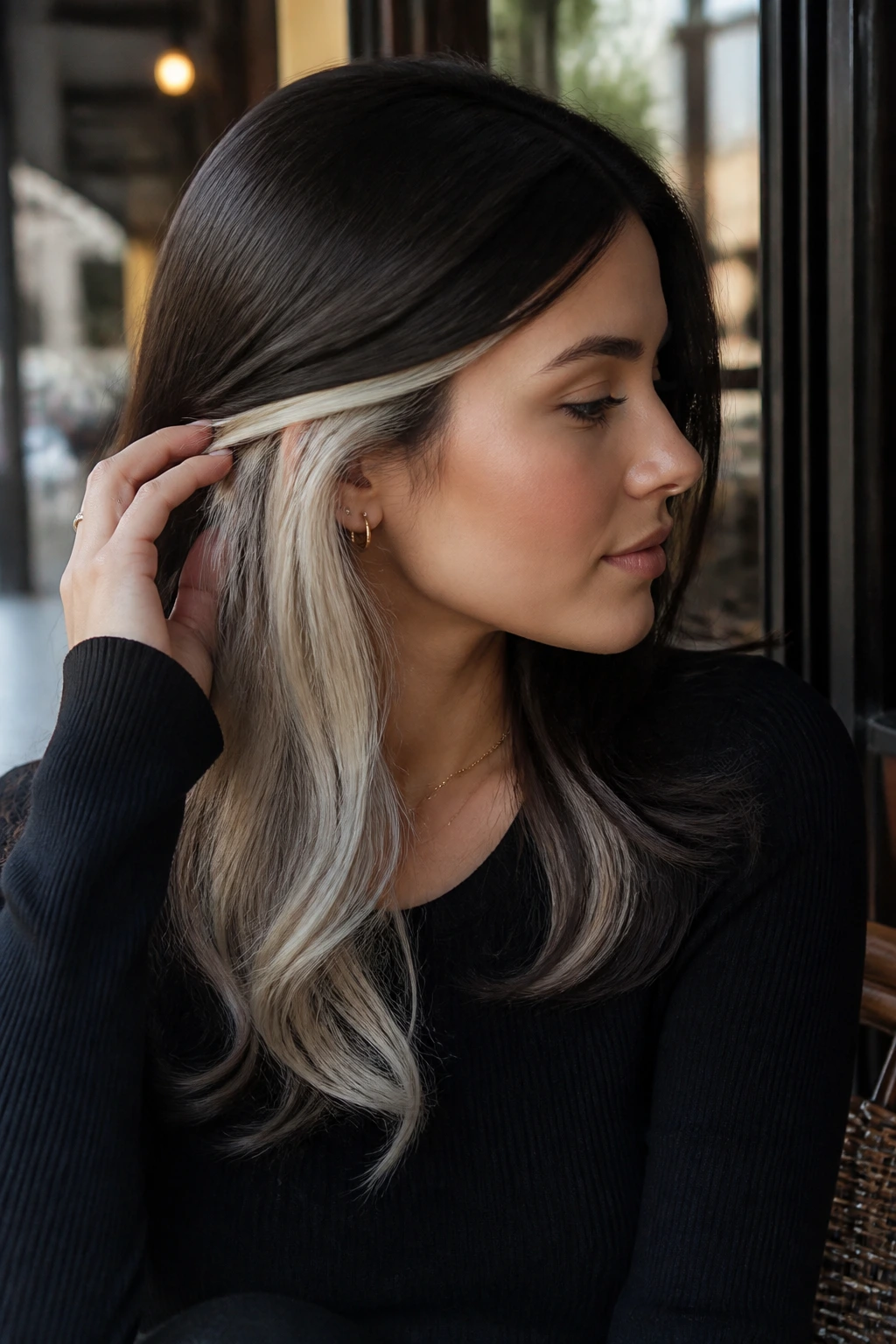 Portrait of a woman with ice brunette flip and underlit blonde panels