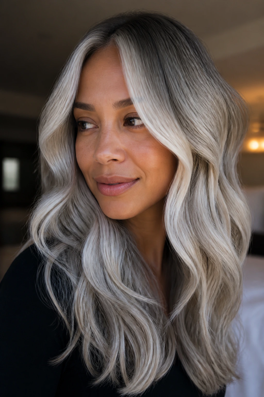 Close-up of a woman with icy silver curtain waves and face-framing highlights.