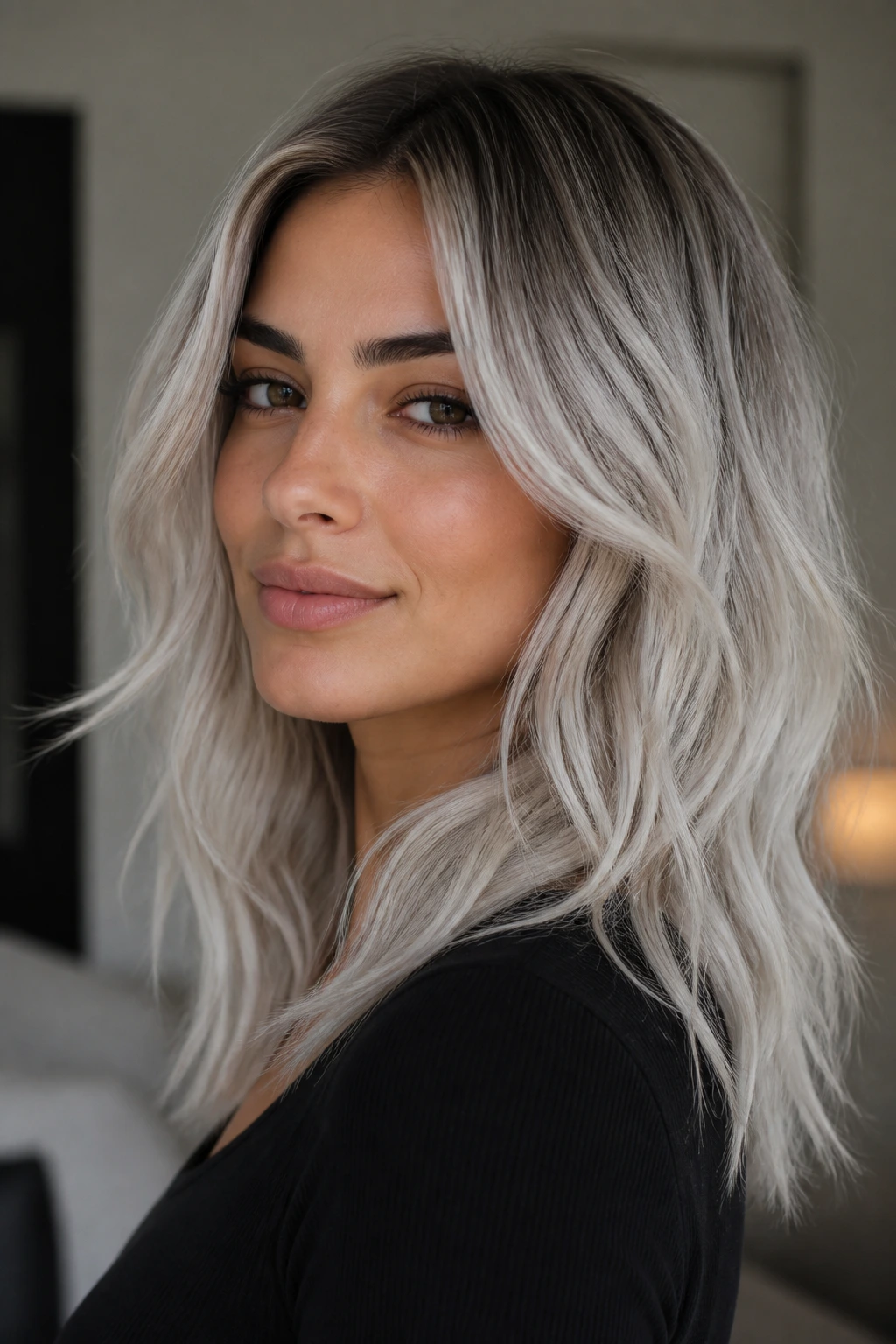 Portrait of olive-skinned person with smoky icy platinum hair flattering the skin.
