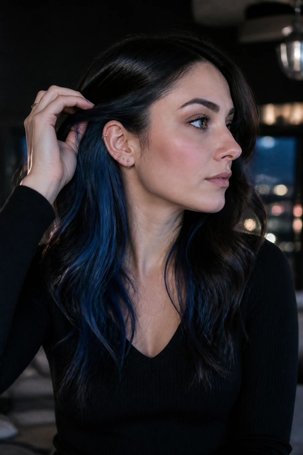 Close-up of a real person showing ink blue underlights under dark hair.