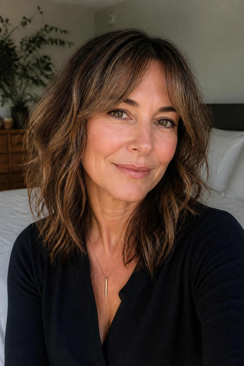 Portrait of a woman with invisible bangs blending into face-framing layers