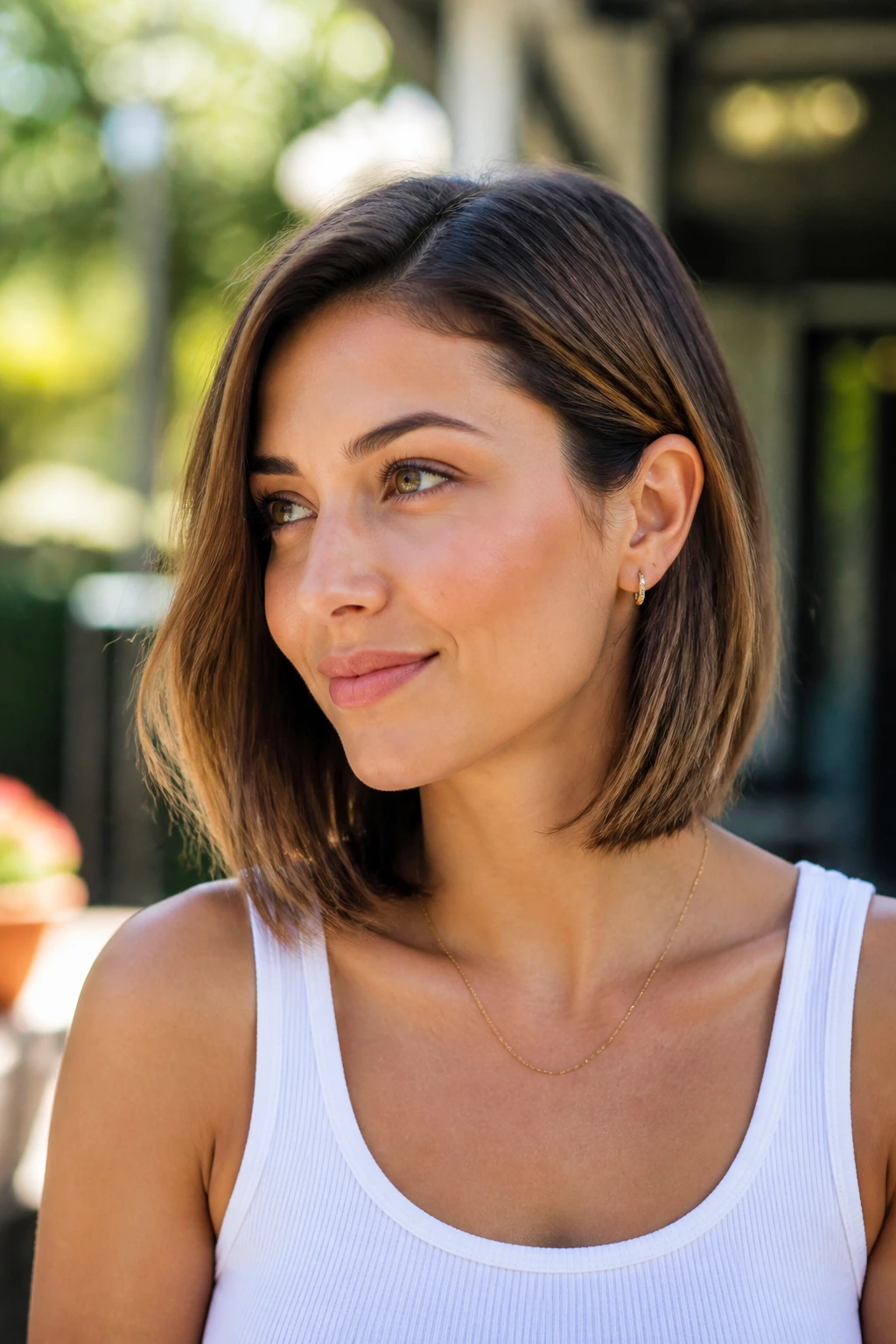 Real-life portrait of a woman with a tucked-behind-ear lob hairstyle outdoors