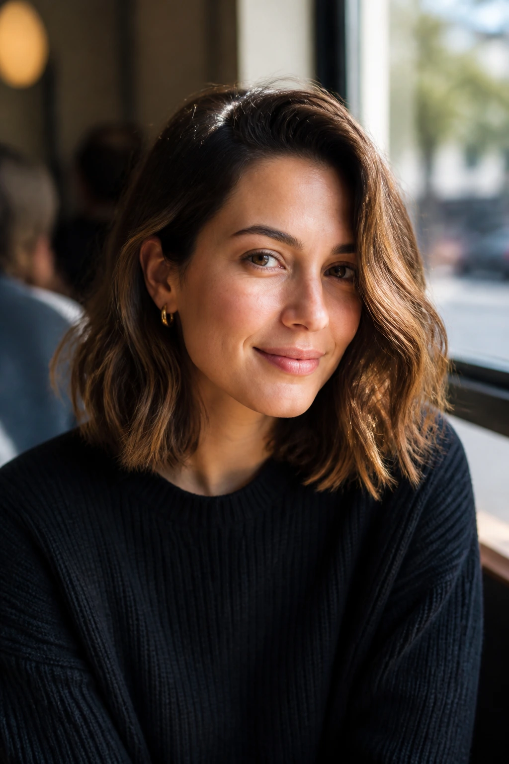 Medium close-up of a real woman with a long bob and invisible layers