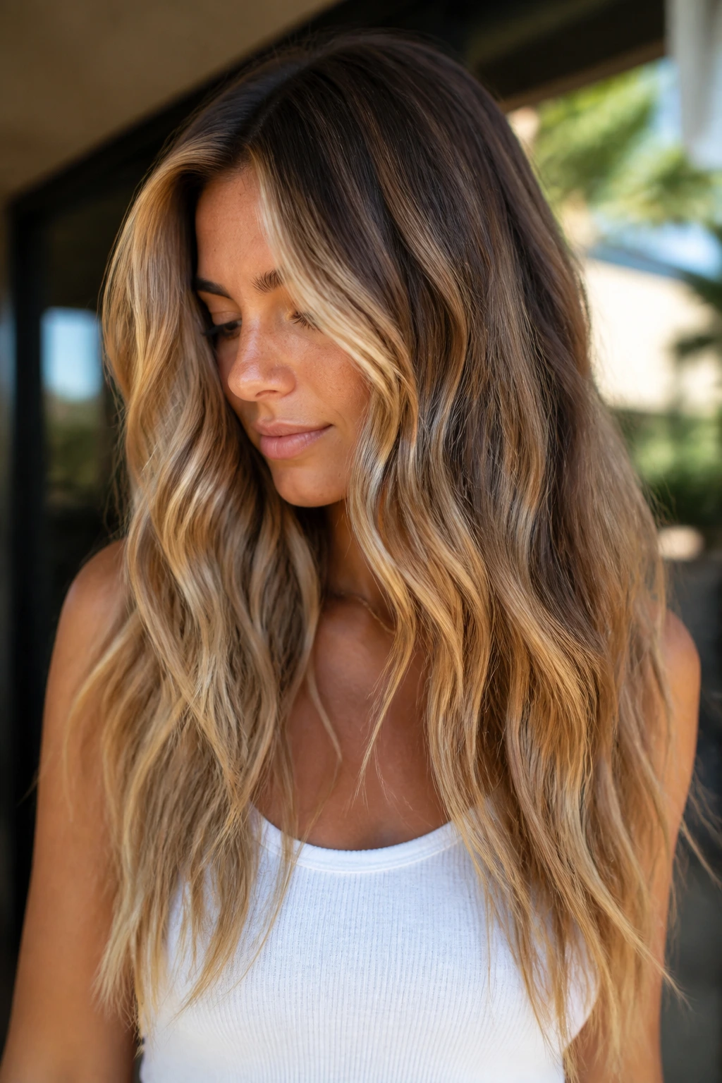 Long hair with beachy waves and shadow-root honey balayage