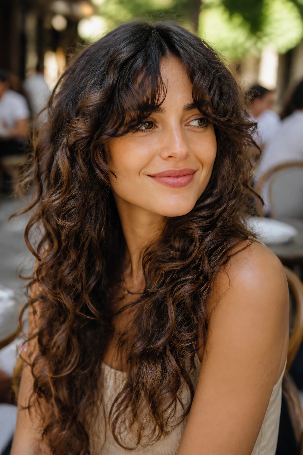 Close-up of long layered curls with draped fringe on a real person.