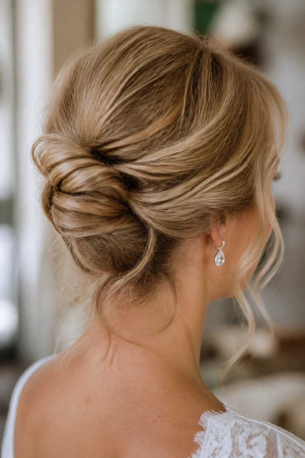 Real woman with loose French twist at the nape in a bridal setting