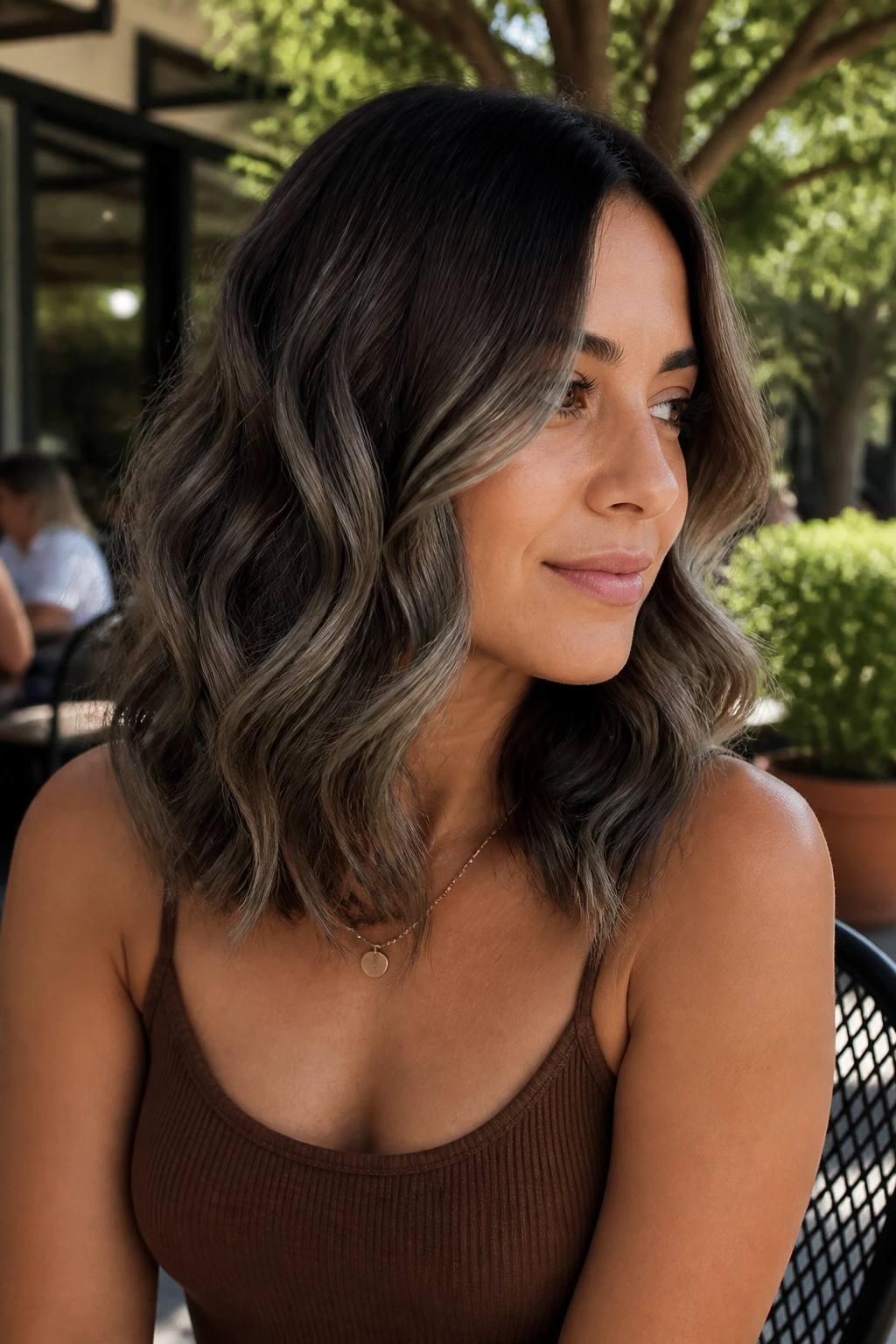 Close-up of real person with loose waves and mushroom balayage transition