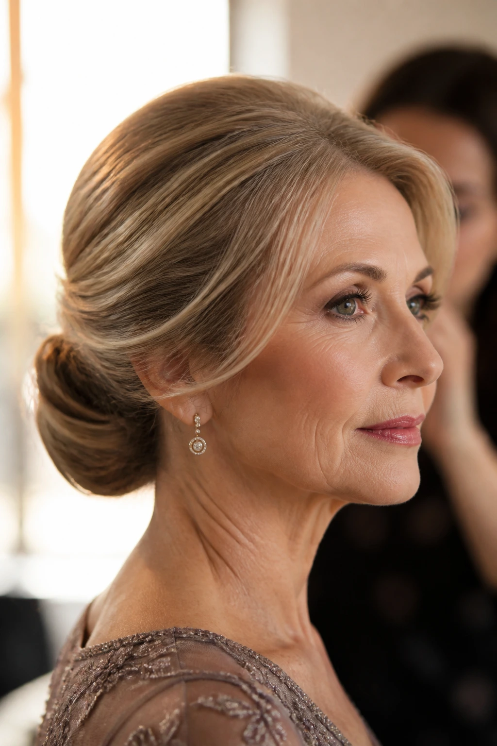 Close-up of a real woman with a low bun for fine hair in warm window light