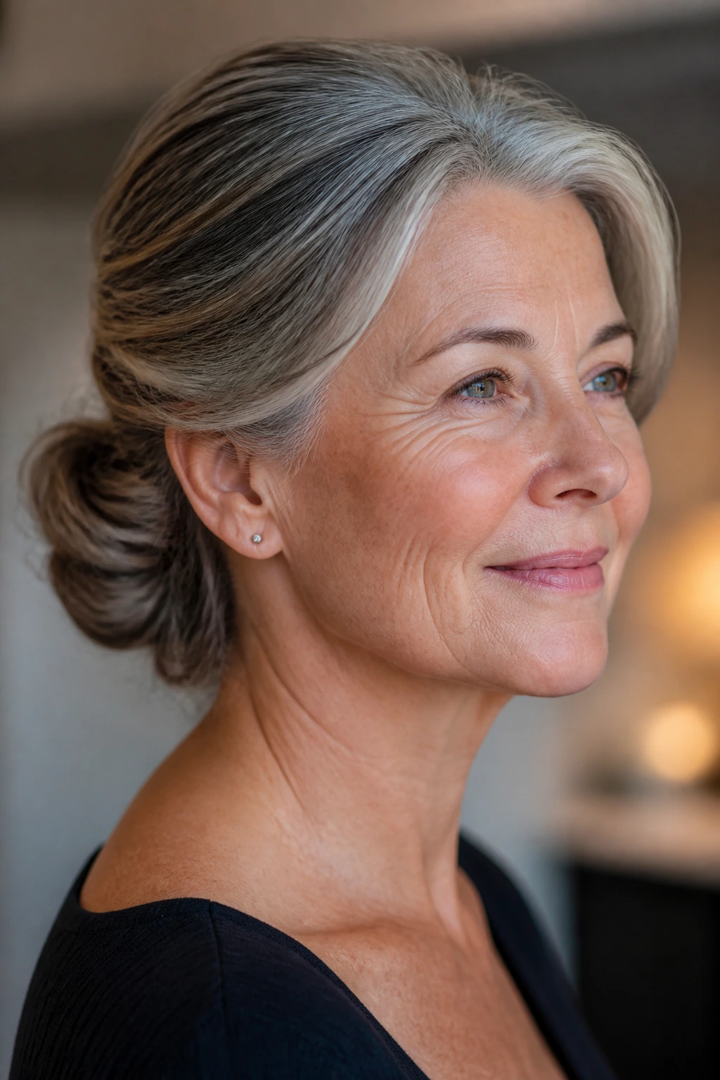 Close-up of a real woman with a low chignon and swept-back sides