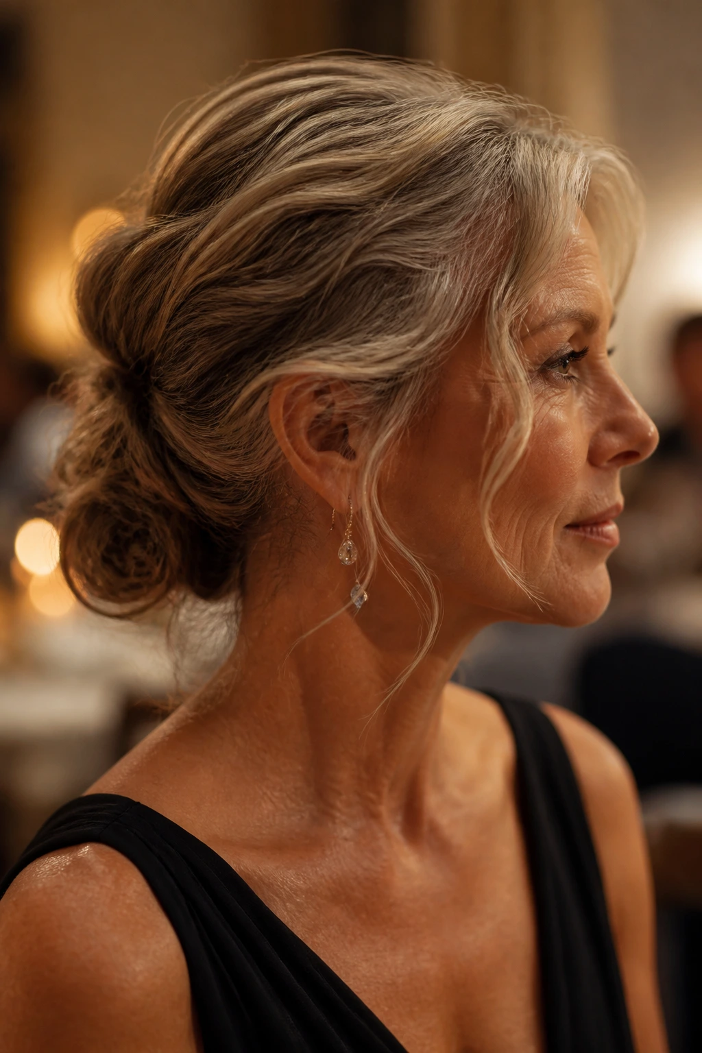 Close-up of a real woman with a low chignon and loose tendrils