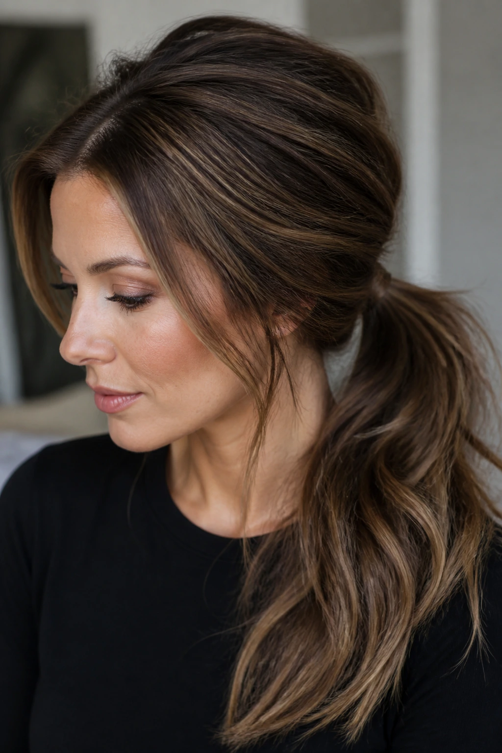 Close-up of low ponytail with teased crown showing volume and lowlights