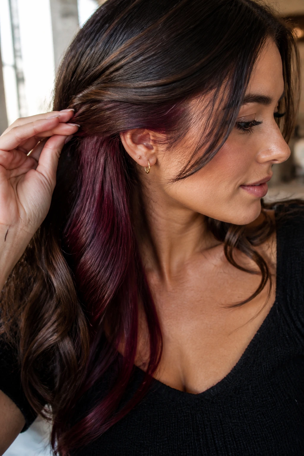 Brunette with merlot peekaboo lowlights peeking through under top layer