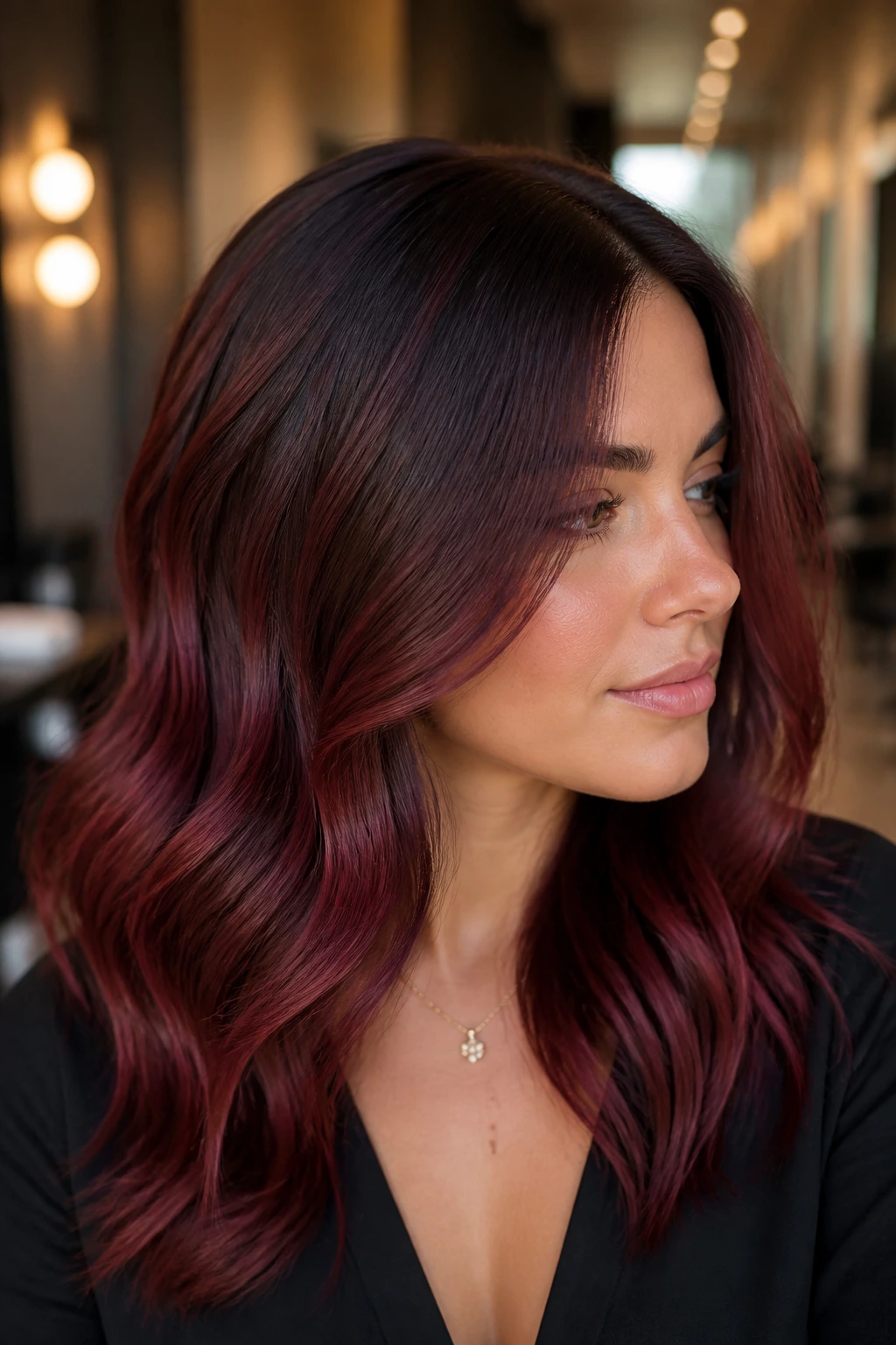 Portrait showing merlot root shadow with darker roots and merlot below on brunette hair