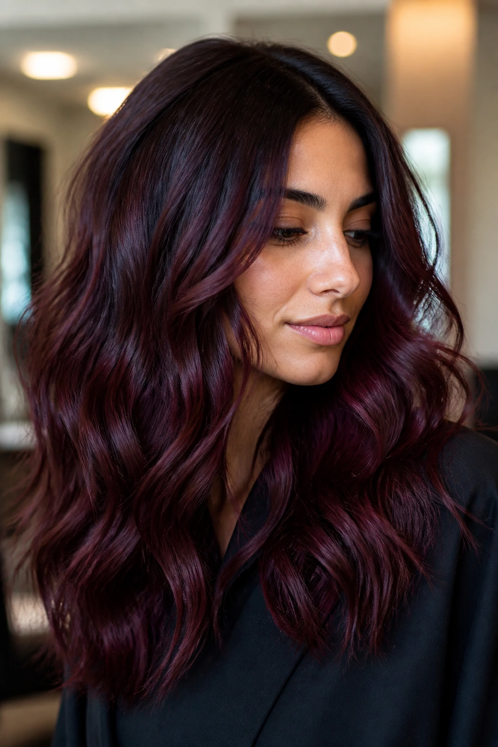 Close-up portrait of a woman showing merlot shadow lights with deep wine tones in hair