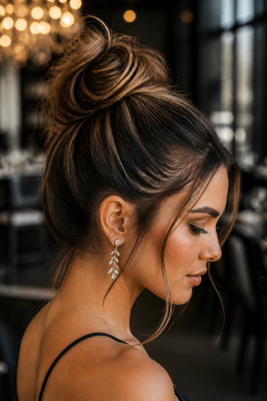 Profile of a real woman with a polished-edged messy top knot