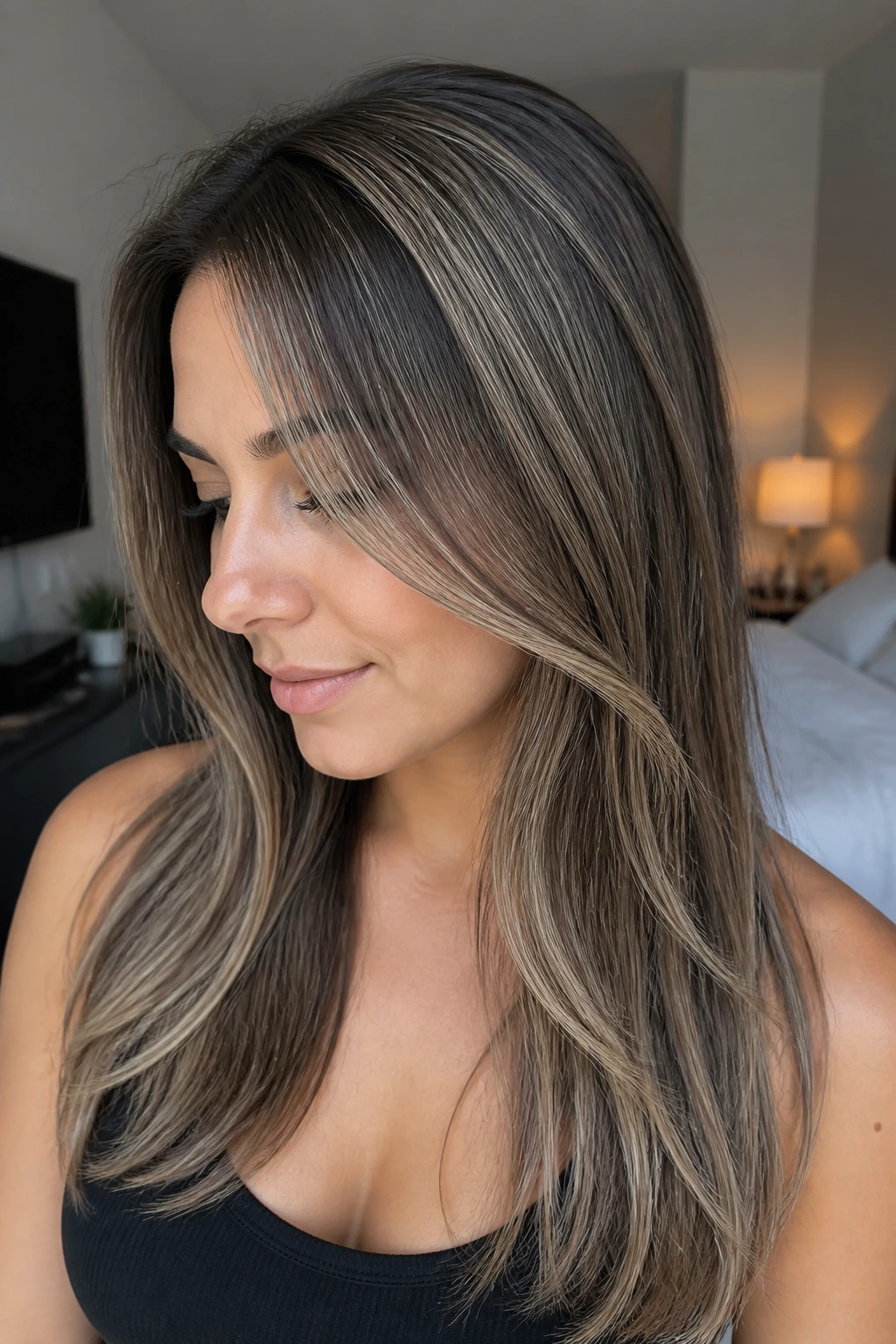 Close-up of a real woman with micro-balayage highlights on fine hair.