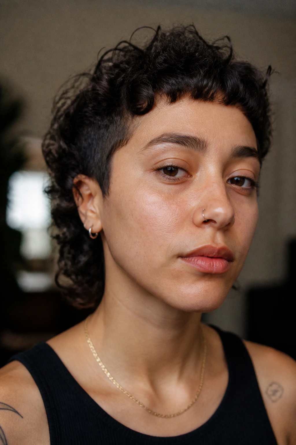 Close-up of a person with micro-fringe curly cut