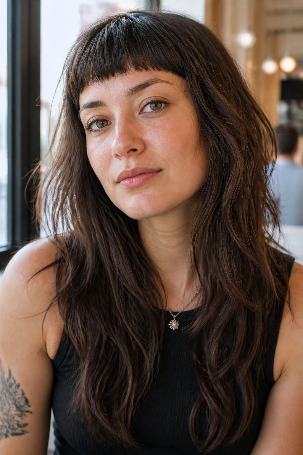 Close-up portrait of a real woman with micro fringe and long layers