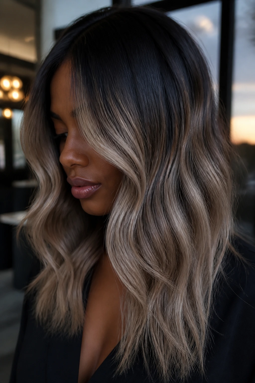 Close-up of deep skin with midnight-root ash blonde balayage.