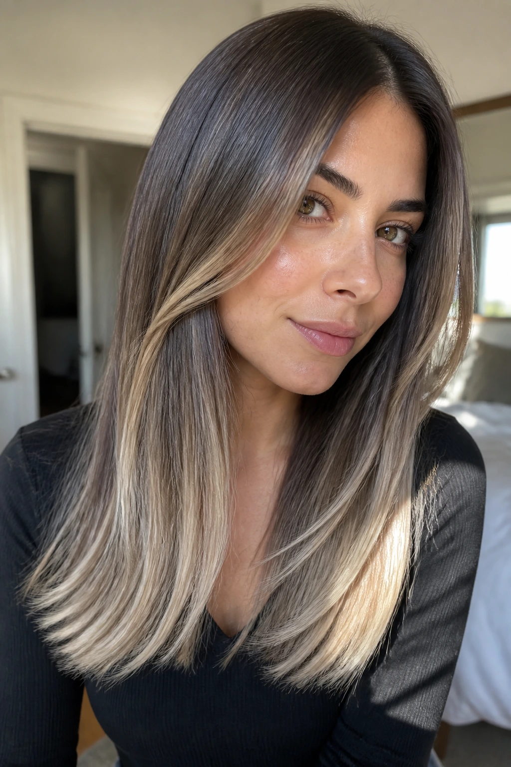 Close-up portrait of a real woman showing cool mocha hair with almond ends in natural window light