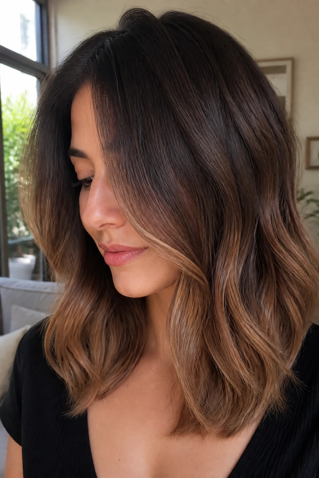 Brunette with mocha melt gradient and caramel ends in soft daylight