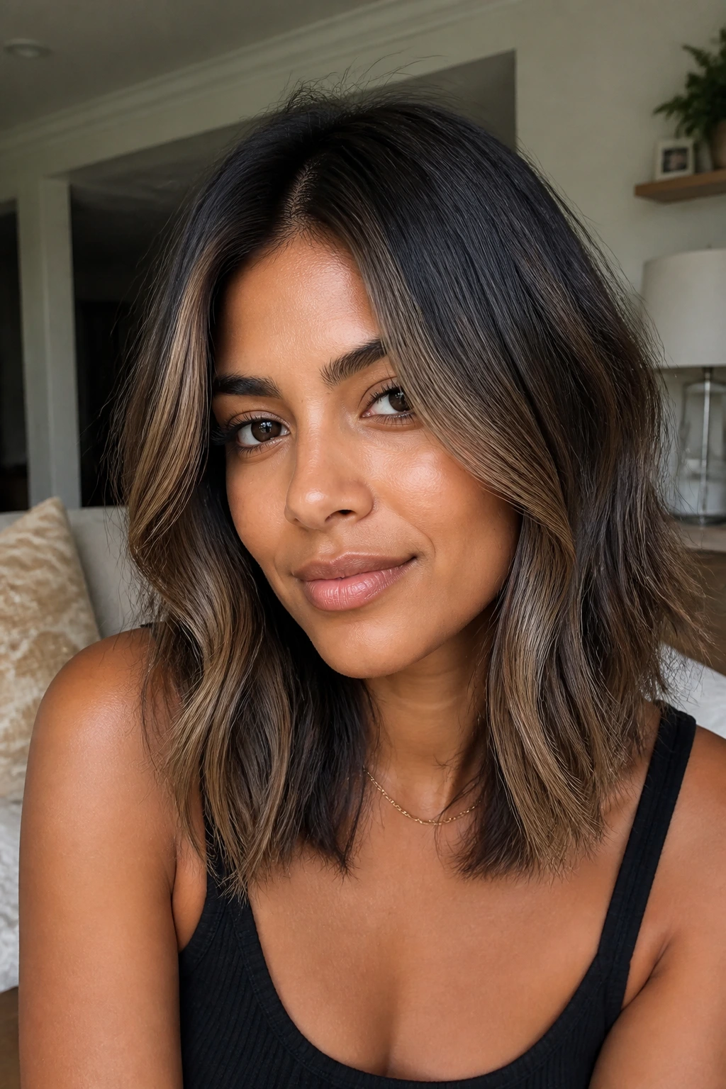 Real woman with mocha money piece on mid-length hair framing the face
