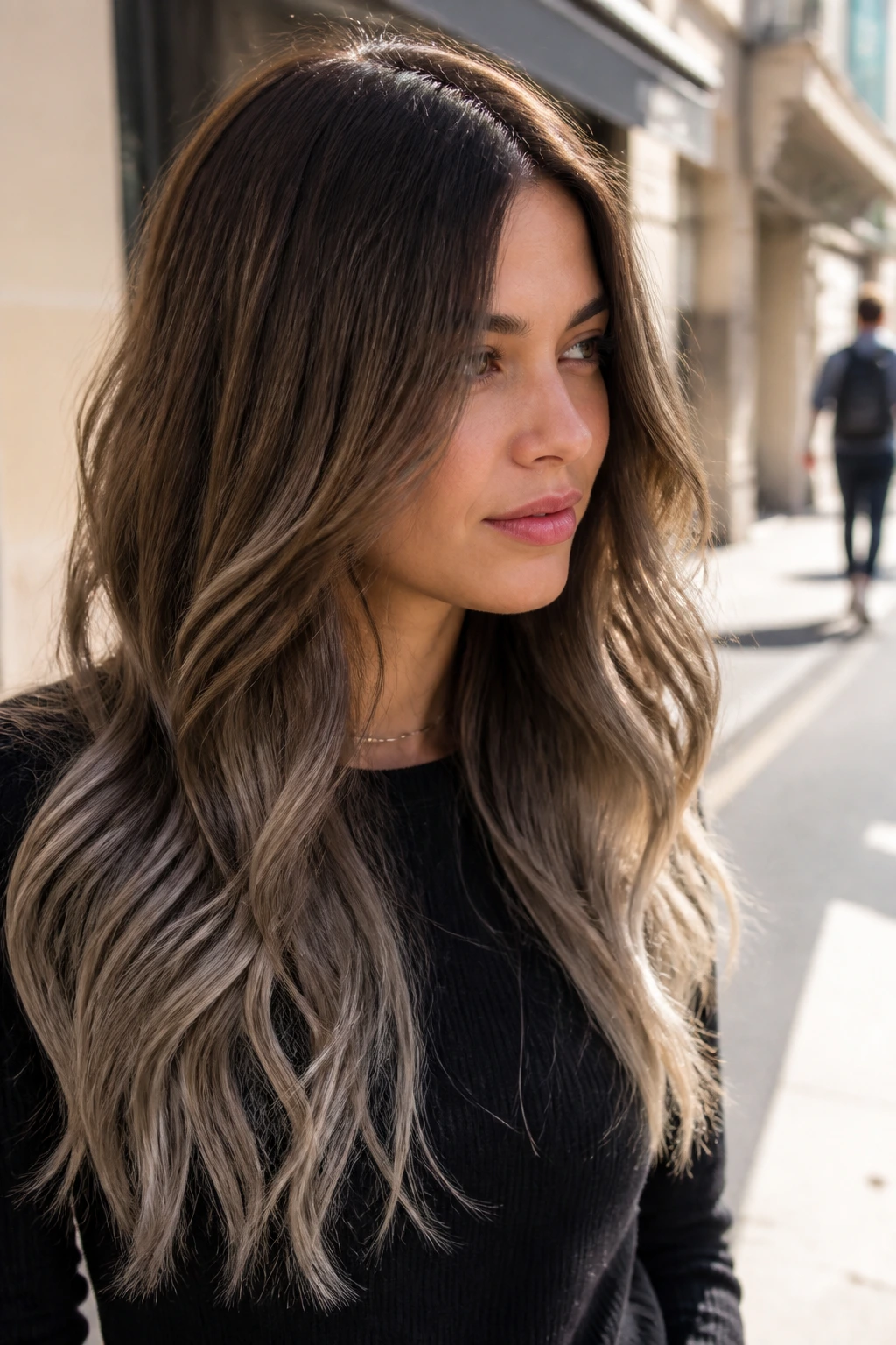 Medium close-up of mocha-to-taupe gradient hair with loose waves outdoors