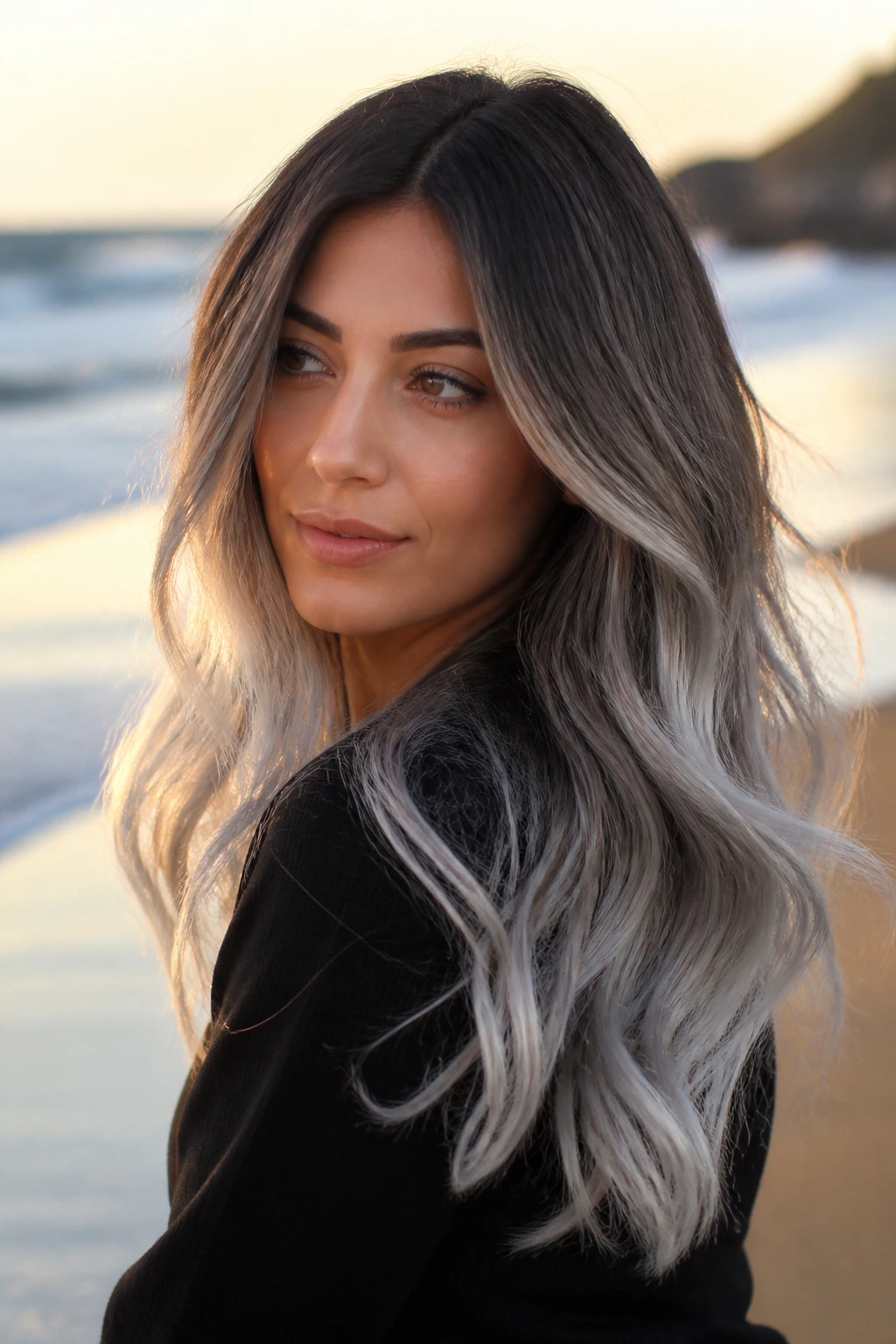 Portrait of a real person with moonstone ombré ends, dark roots fading to silver.