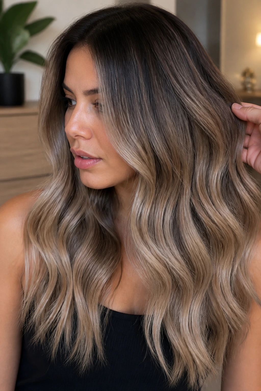 Close-up of mushroom bronde melt on dark hair with taupe beige tones