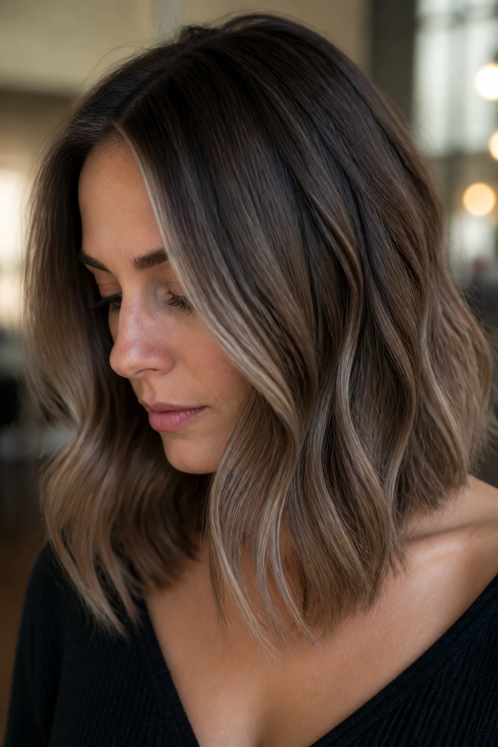 Portrait of a person with mushroom brown balayage showing muted beige tones