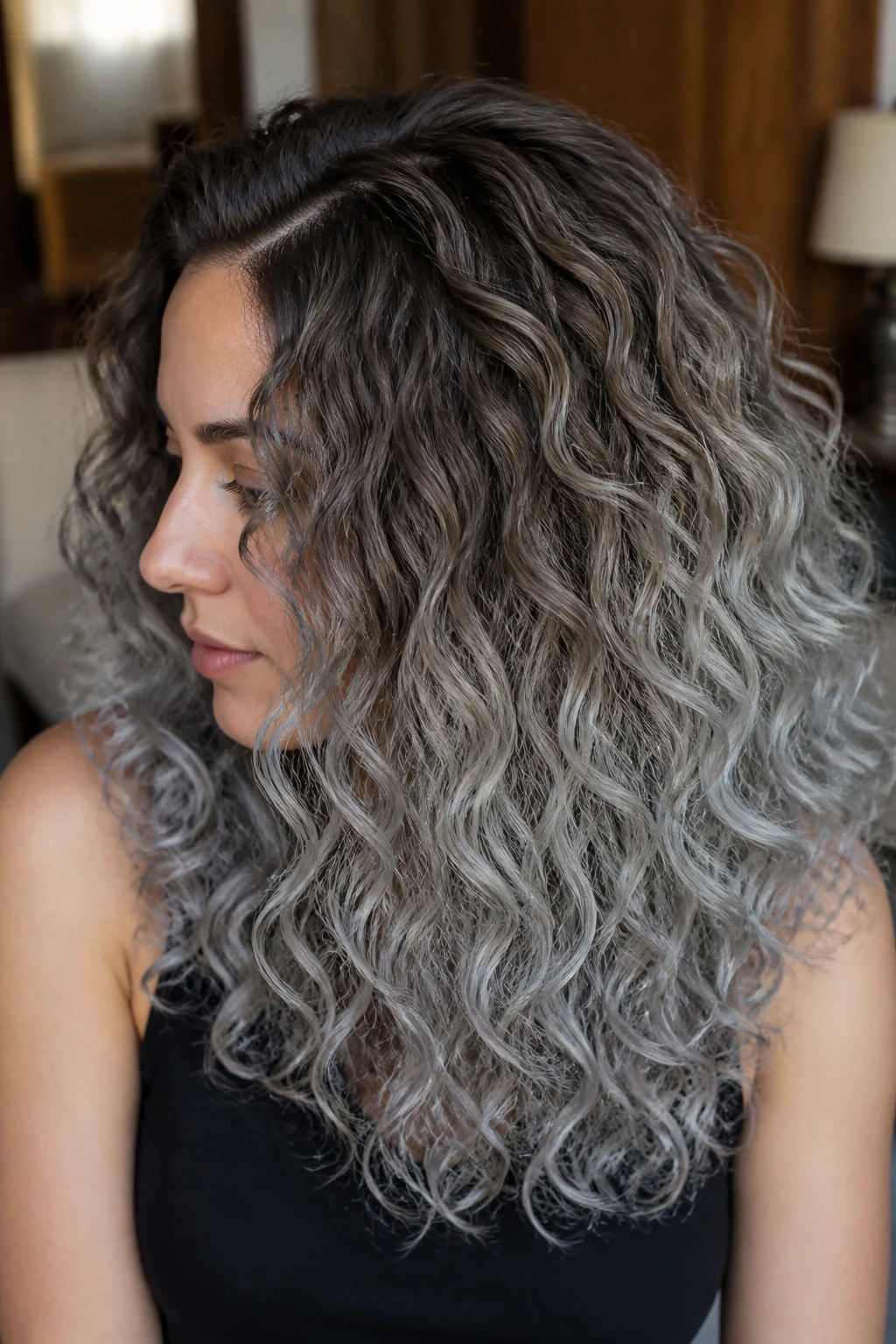 Close-up of brunette curls transitioning from mushroom brown to silver