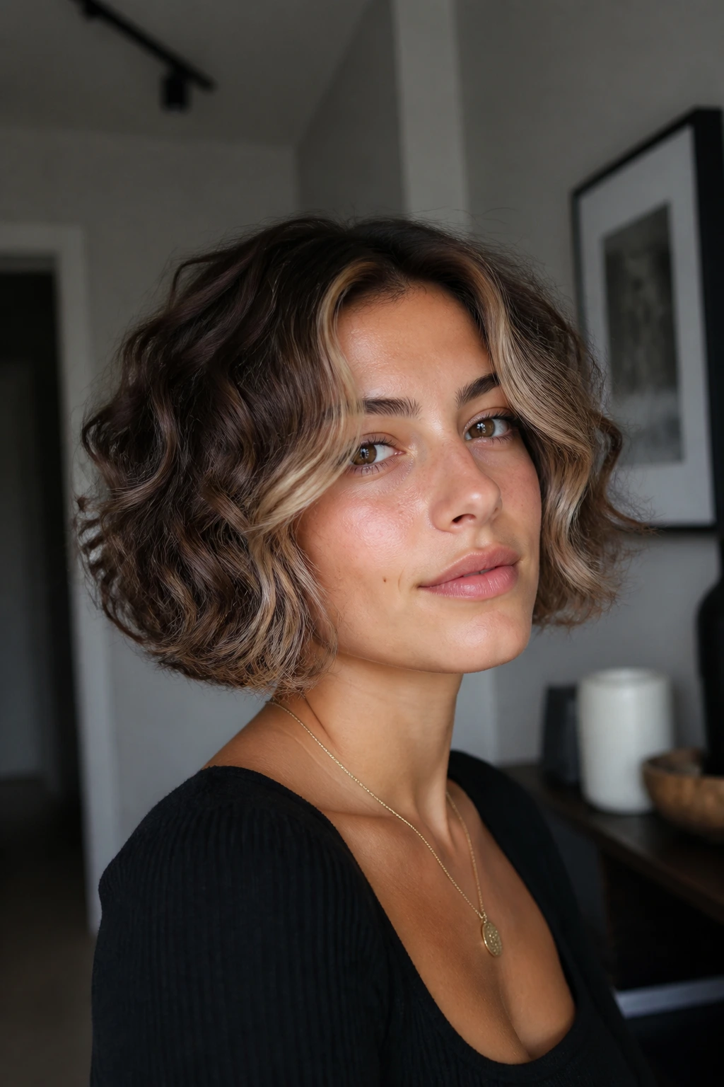 Close-up of a real woman's mushroom curly bob with ash beige money piece
