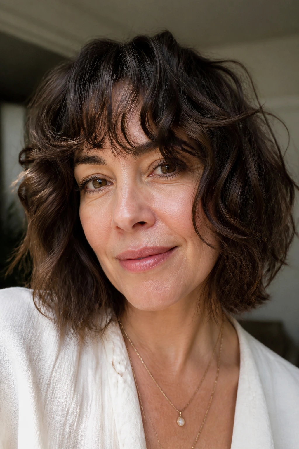 Real woman with natural wave bob and curly curtain bangs
