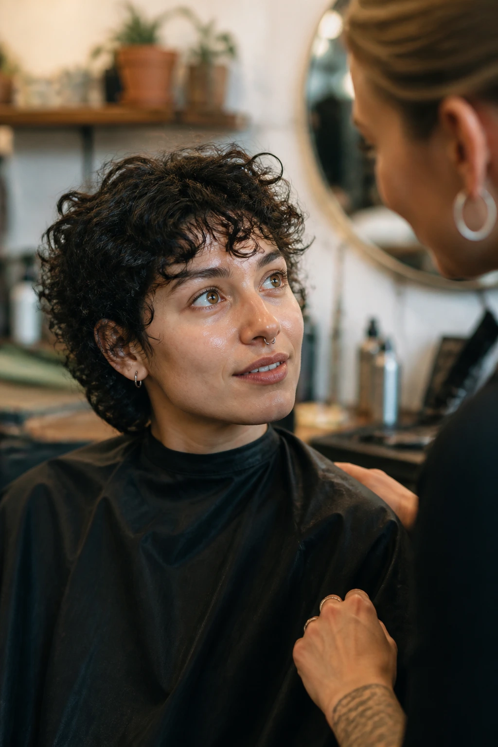 Close-up of a real client in a salon discussing nonbinary curly haircut options