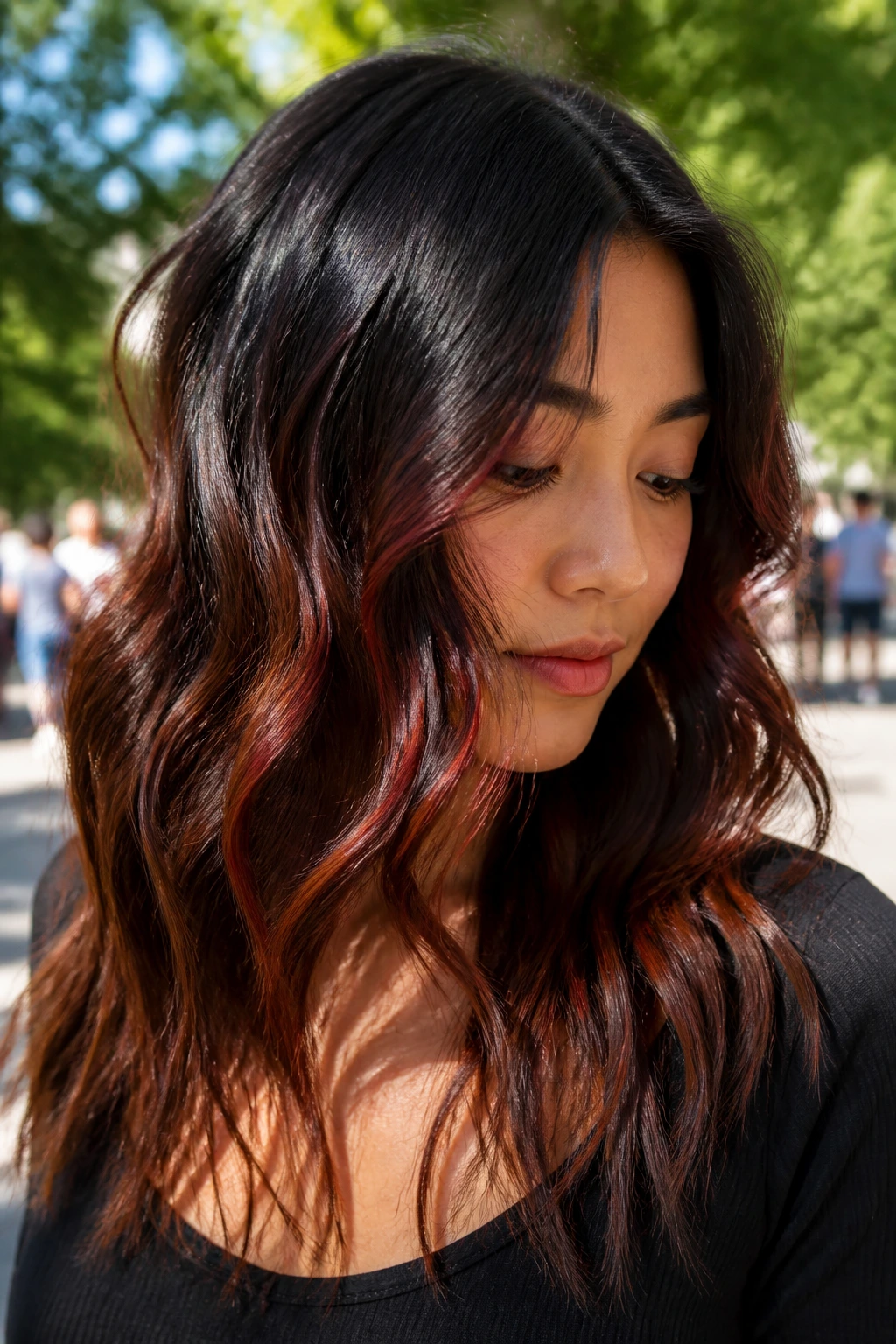 Close-up of real woman with paprika-red glow in dark wavy hair