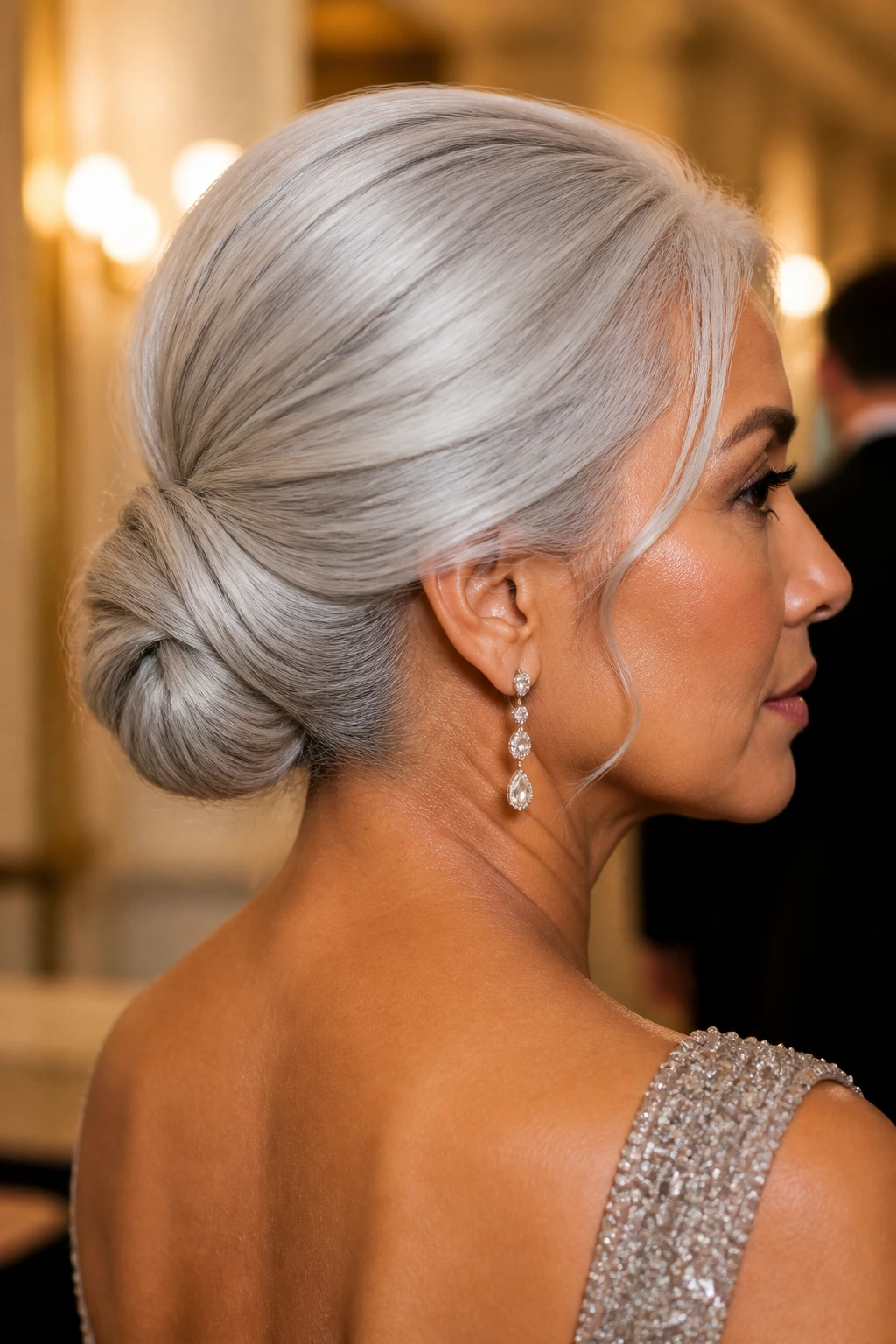 Portrait of a woman with a pearl-silver low chignon.