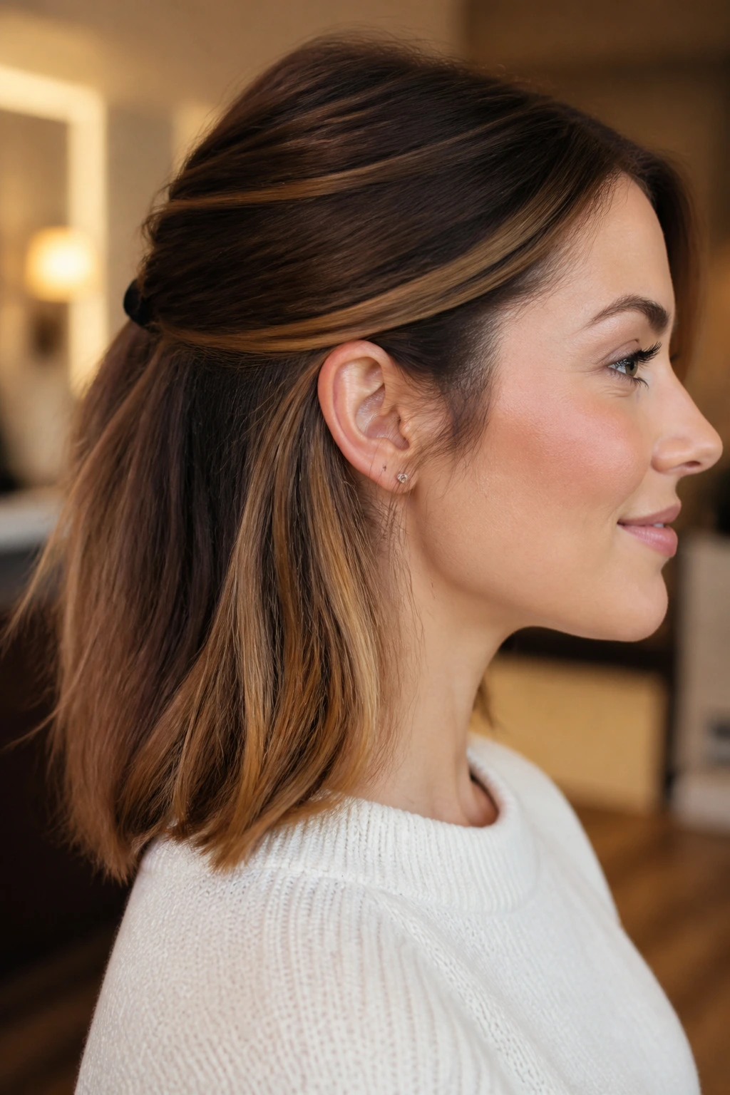 Underlayer caramel peekaboo color visible at nape and sides on a real person