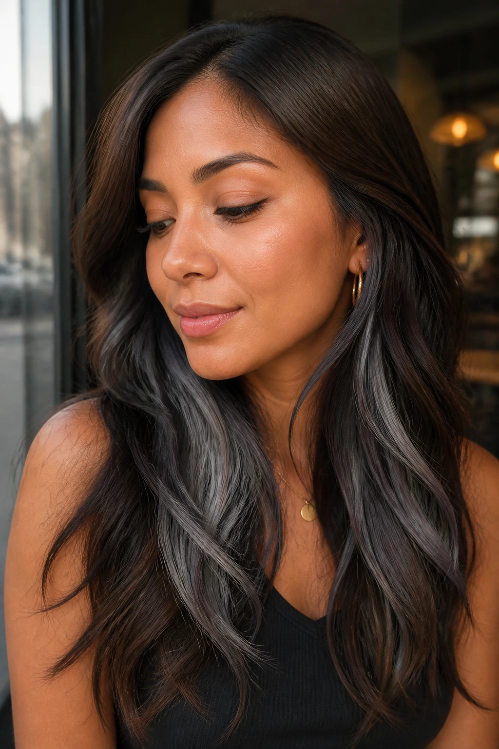 Close-up of a real woman with Peekaboo Grey Underlayer on Brunette Hair