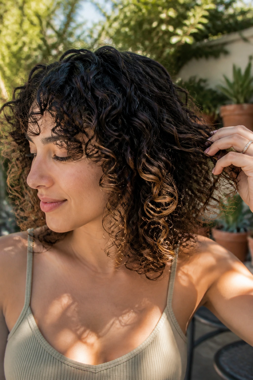 Close-up of a real woman with dimensional peekaboo highlights under curls