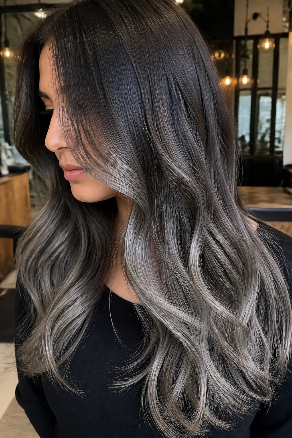 Close-up of long layered brunette with pewter balayage highlighting.