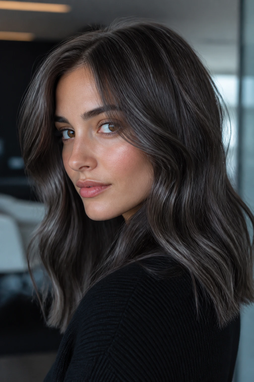 Close-up portrait of pewter brunette hair with cool gloss on a real person
