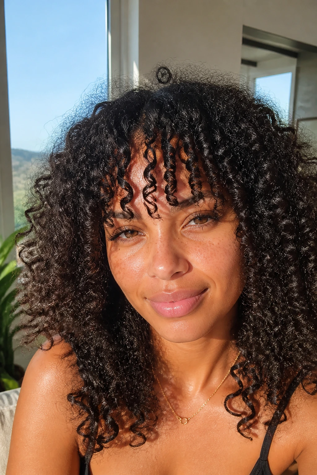 Piecey bangs on a real woman's dense curls