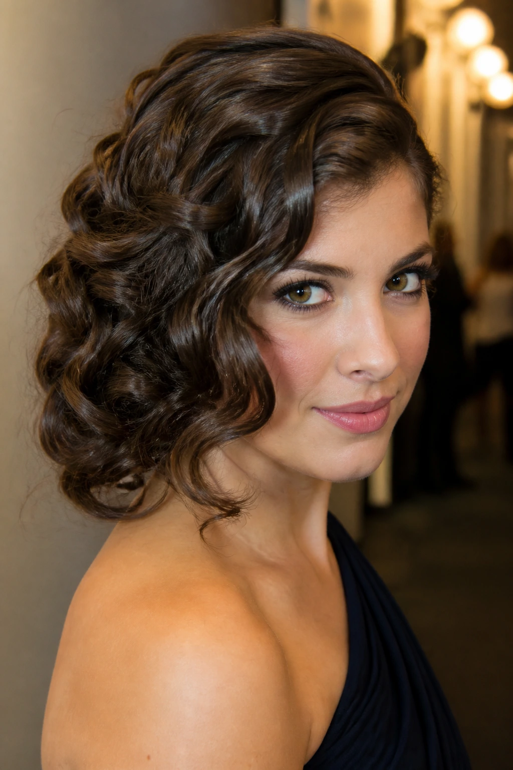 Real woman with side-swept pinned curls in a portrait.