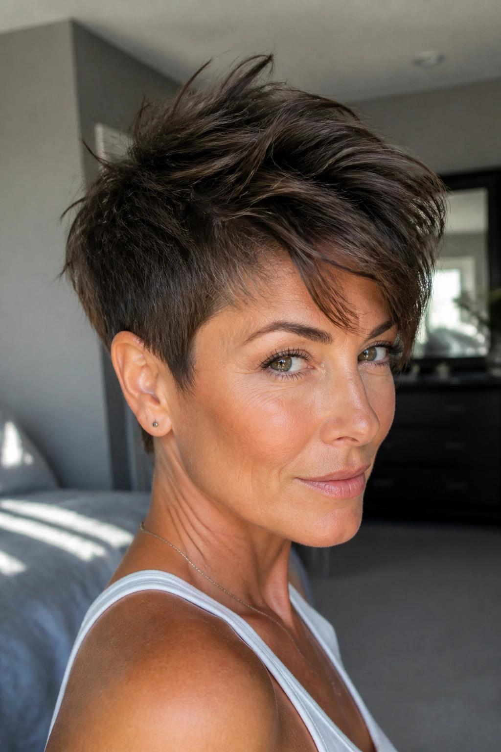 Close-up portrait of a real woman with a long-top pixie cut