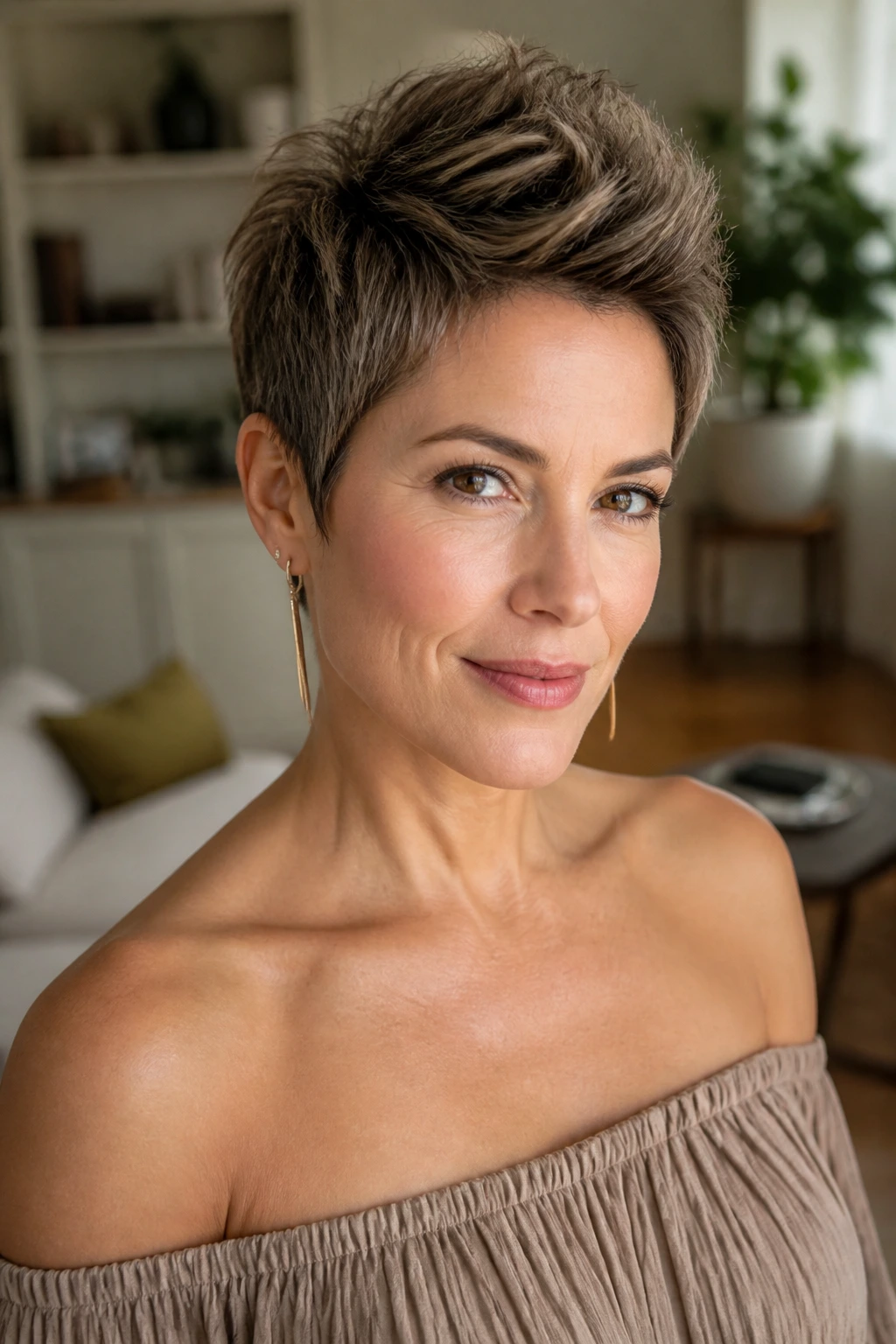 Close-up of textured pixie with lifted crown and off-shoulder dress.
