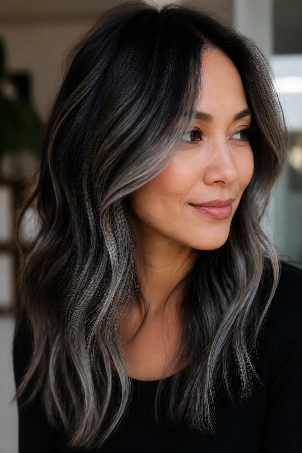 Portrait of a real person with dark hair showing grey placement around the face and ends.