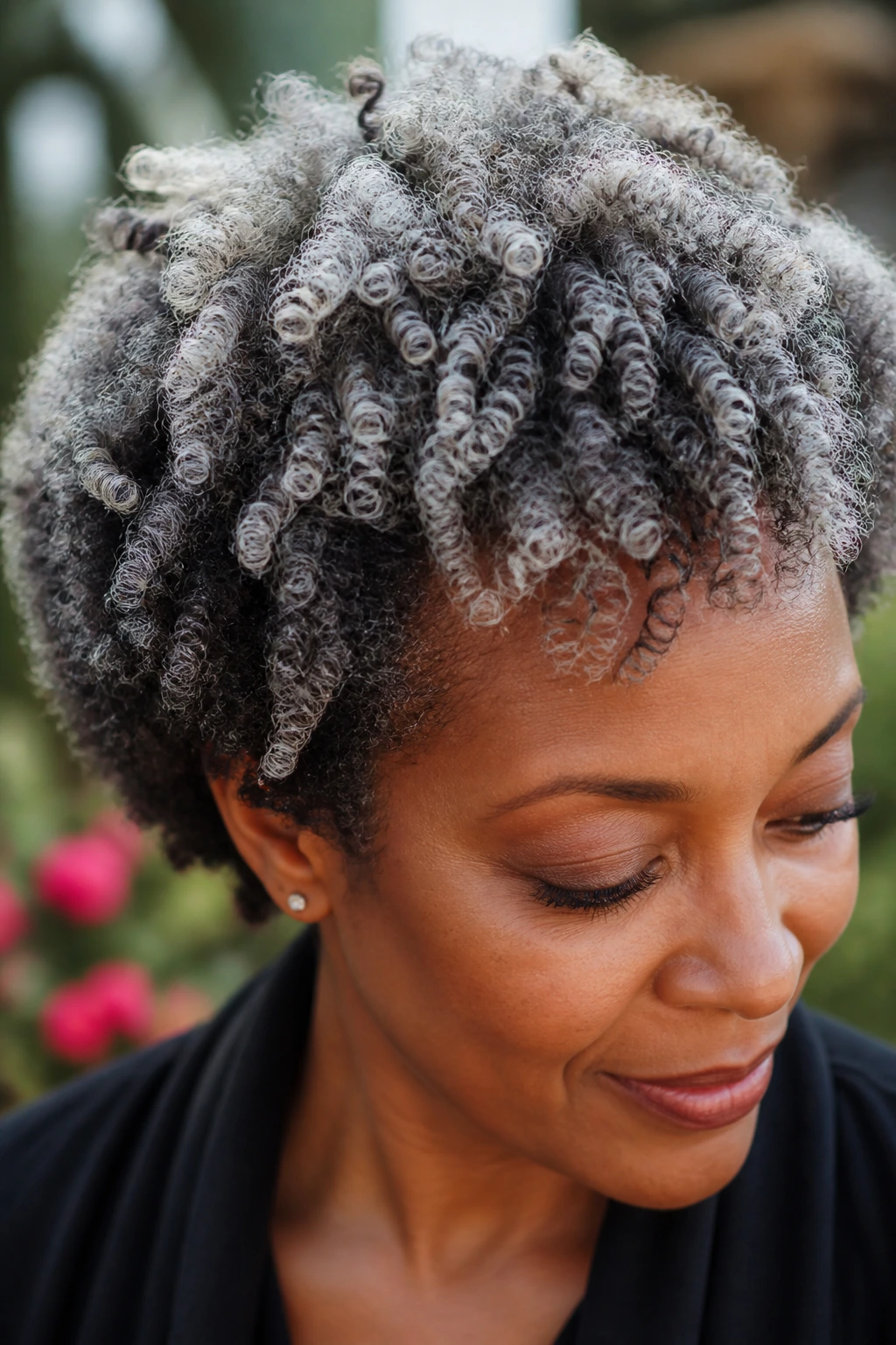 Close-up of real person with platinum mist on coily layers showing depth in curls.