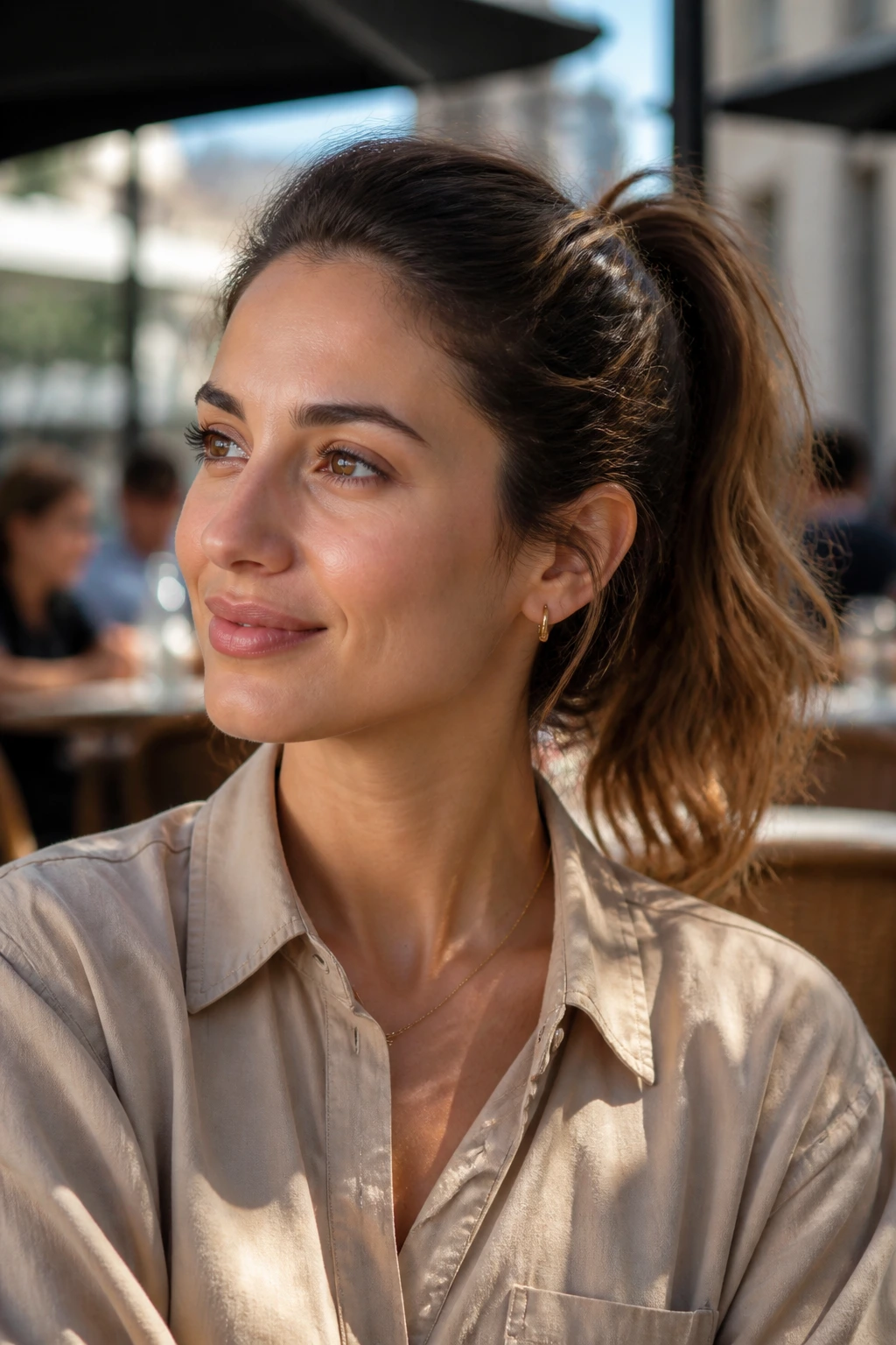 Portrait of a woman with ponytail showing medium-length hair and oval face in daylight