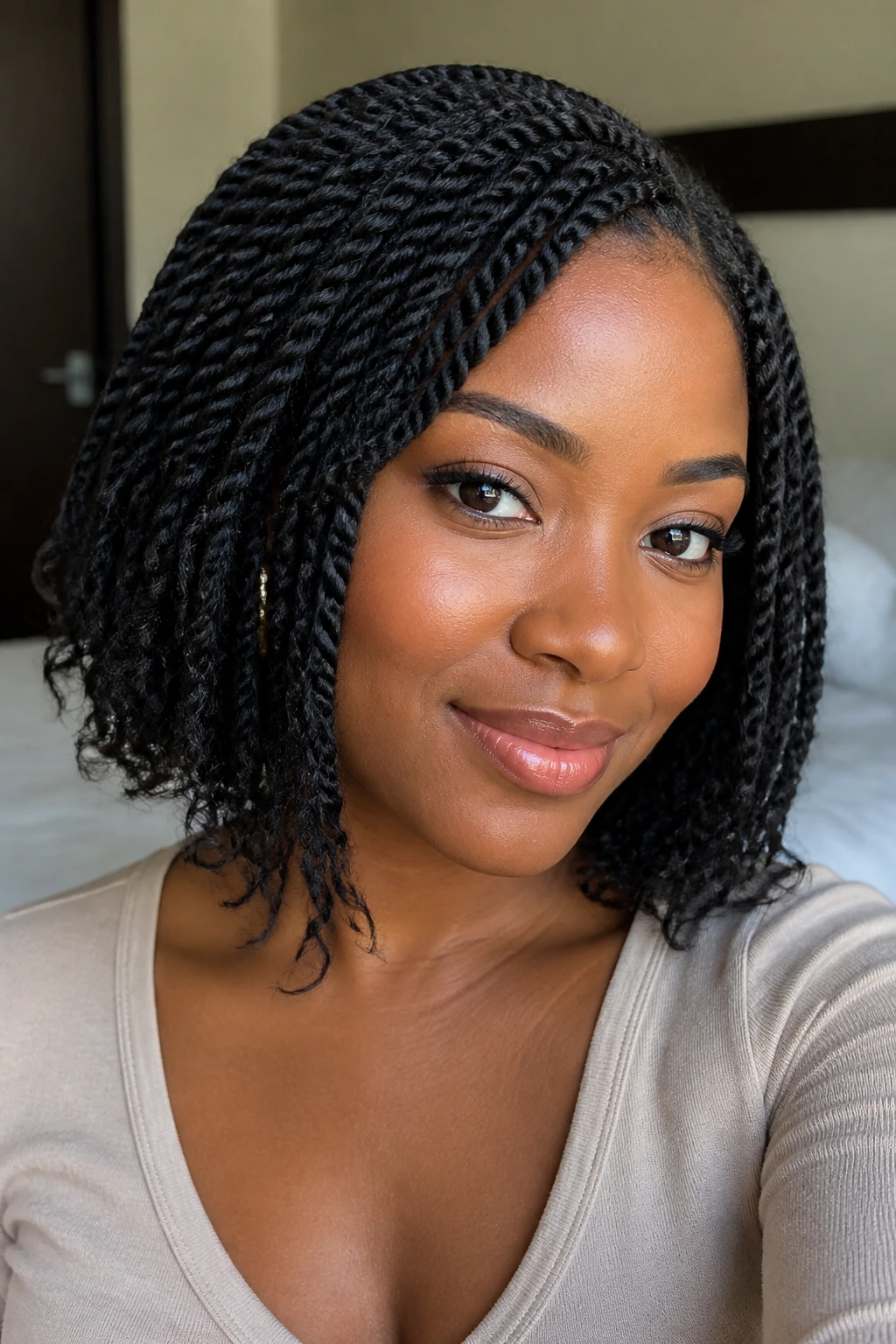 Close-up of a real woman with protective twists at bob length in soft light